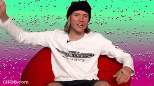 A Man Wearing A Sega Drive Shirt Is Sitting On A Bean Bag Chair . GIF