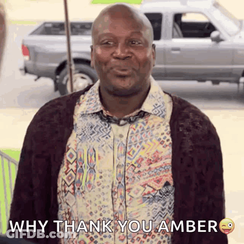A Man Wearing A Shirt And Tie Is Smiling And Says Why Thank You Amber GIF