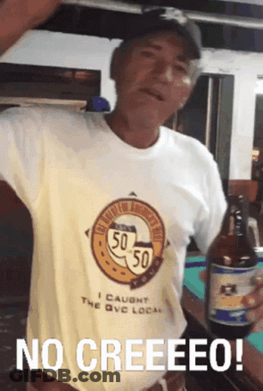 A Man Wearing A Shirt That Says 50 50 Is Holding A Beer Bottle GIF