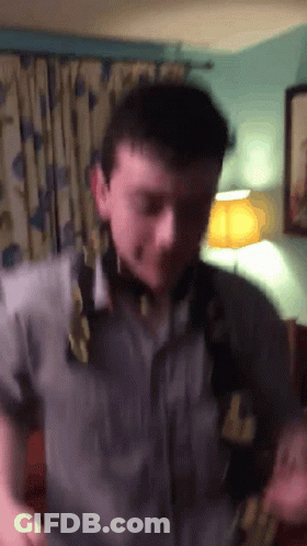 A Man Wearing A Shirt That Says ' Abercrombie & Fitch ' On It Is Standing In A Room GIF