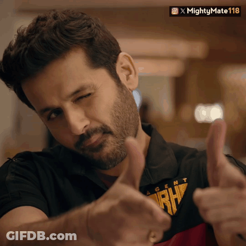 A Man Wearing A Shirt That Says Agent Rh Is Giving Two Thumbs Up GIF