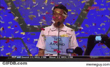A Man Wearing A Shirt That Says Arvind Is Standing In Front Of A Microphone GIF