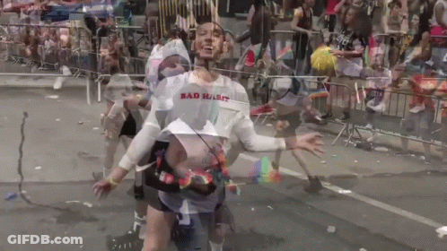 A Man Wearing A Shirt That Says Bad Habit Is Dancing In Front Of A Crowd GIF