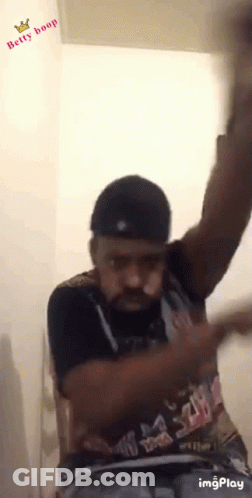 A Man Wearing A Shirt That Says Betty Boop Is Dancing GIF