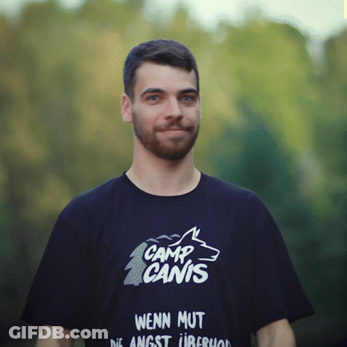 A Man Wearing A Shirt That Says Camp Canis On It GIF