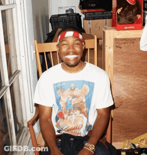 A Man Wearing A Shirt That Says Capcom Is Smiling GIF