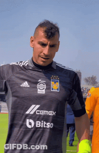A Man Wearing A Shirt That Says Cemex Bitso On It GIF