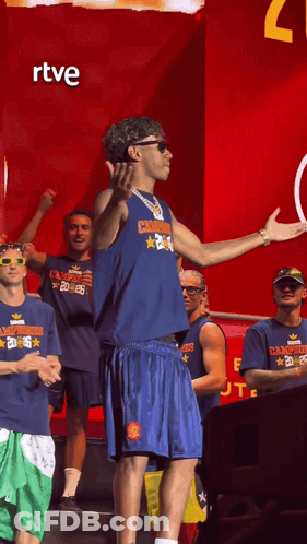 A Man Wearing A Shirt That Says ' Champions ' On It GIF