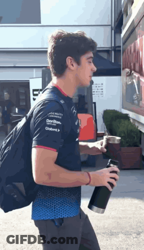 A Man Wearing A Shirt That Says ' Dorito ' On The Sleeve GIF