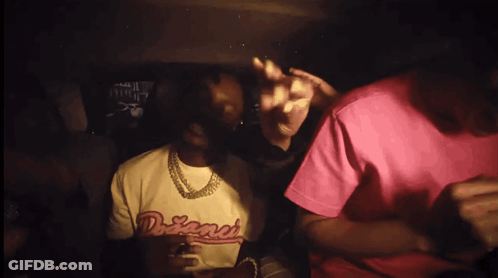 A Man Wearing A Shirt That Says Dreamer Is Sitting In A Car GIF