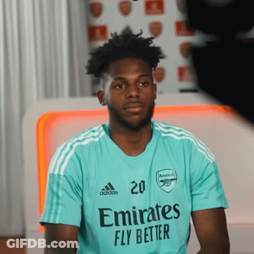 A Man Wearing A Shirt That Says Emirates Fly Better On It GIF