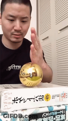 A Man Wearing A Shirt That Says ' Faith ' On It Holds A Gold Ball GIF