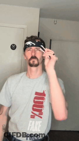 A Man Wearing A Shirt That Says Fake Free GIF