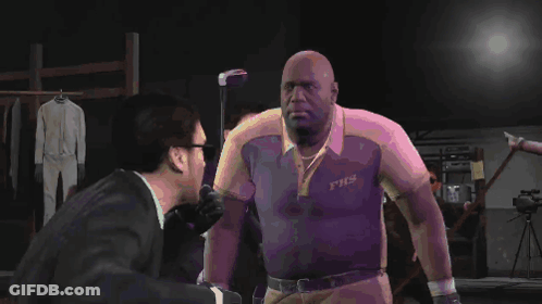 A Man Wearing A Shirt That Says Fhs Shakes Hands With Another Man In A Suit GIF