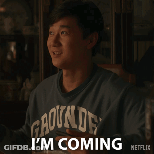 A Man Wearing A Shirt That Says Gaounde On It Says I 'M Coming GIF