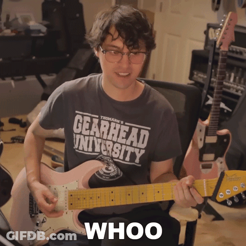 Man Playing Guitar Wearing Gearhead University Shirt GIF