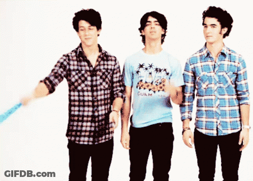 A Man Wearing A Shirt That Says Guam Is Standing Next To Two Other Men GIF