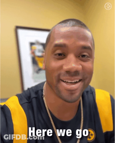 A Man Wearing A Shirt That Says Here We Go On It GIF