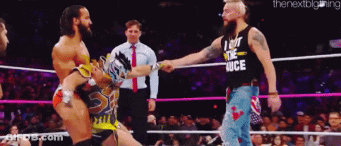A Man Wearing A Shirt That Says I Got The Juice Shakes Hands With Another Man In A Wrestling Ring GIF