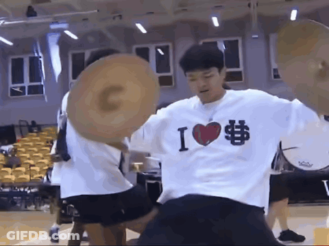 A Man Wearing A Shirt That Says I Love Basketball Is Holding A Basketball GIF