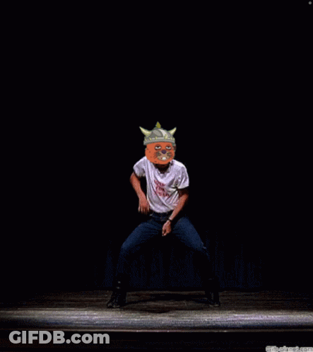A Man Wearing A Shirt That Says ' It 'S A Pig ' On It Stands On A Stage GIF