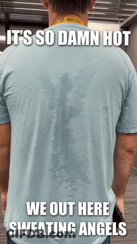 A Man Wearing A Shirt That Says ' It 'S So Damn Hot We Out Here Sweating Angels ' On The Back GIF