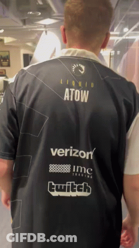 A Man Wearing A Shirt That Says Liquid Atow On The Back GIF