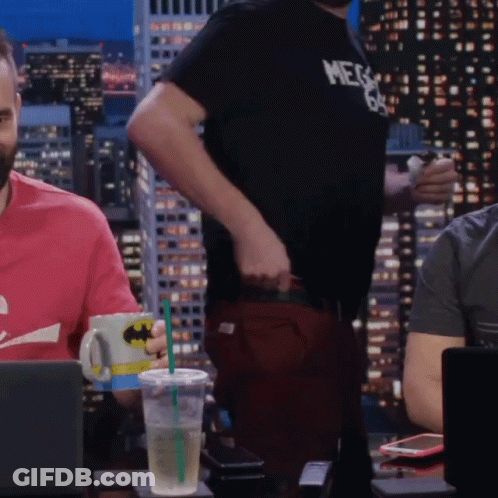 A Man Wearing A Shirt That Says Mega 69 Stands In Front Of A Laptop GIF