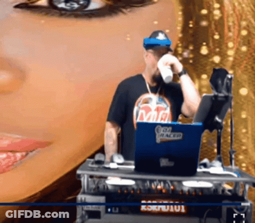 A Man Wearing A Shirt That Says Mr. Racer Stands In Front Of A Laptop GIF