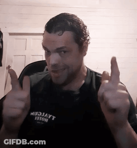 A Man Wearing A Shirt That Says Mudjayt Giving A Thumbs Up GIF