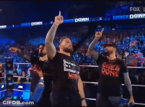 A Man Wearing A Shirt That Says One & Done Is Standing In Front Of A Crowd GIF