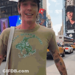 A Man Wearing A Shirt That Says Peak River Rodeo Is Smiling GIF