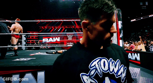 A Man Wearing A Shirt That Says Raw On It GIF