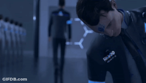 A Man Wearing A Shirt That Says Rk800 Is Looking Down GIF