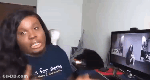 A Man Wearing A Shirt That Says S For Sharing Is Sitting In Front Of A Computer Screen . GIF