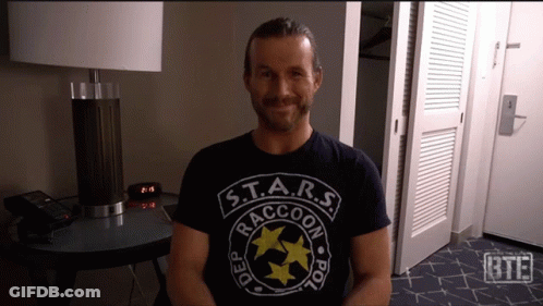 A Man Wearing A Shirt That Says S.t.a.r.s. Raccoon Police GIF