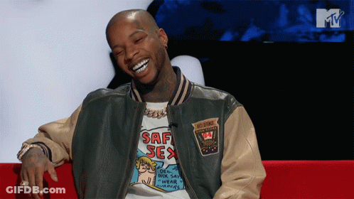 A Man Wearing A Shirt That Says Saf Sex Is Smiling GIF