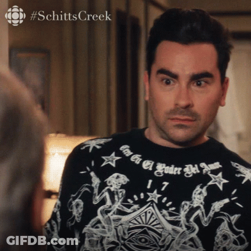 A Man Wearing A Shirt That Says #Schitts Creek GIF