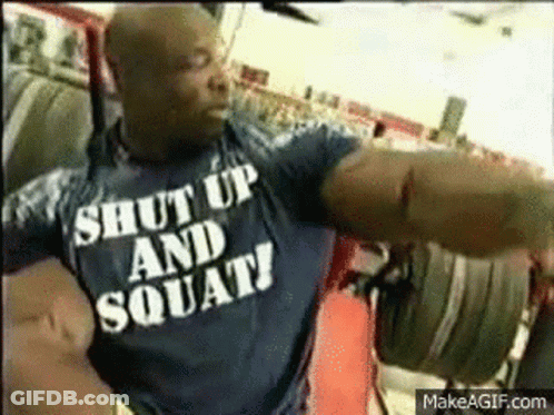 A Man Wearing A Shirt That Says Shut Up And Squats GIF