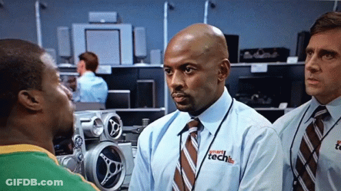 A Man Wearing A Shirt That Says Smart Tech Is Talking To Another Man GIF