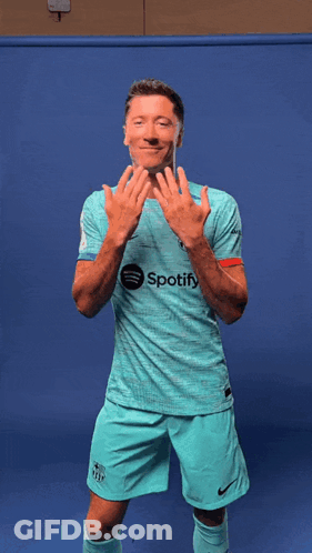 A Man Wearing A Shirt That Says Spotify Is Dancing GIF