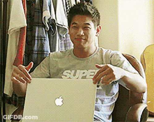 A Man Wearing A Shirt That Says Super Is Holding A Laptop GIF