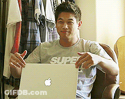 A Man Wearing A Shirt That Says Super Is Holding A Laptop GIF
