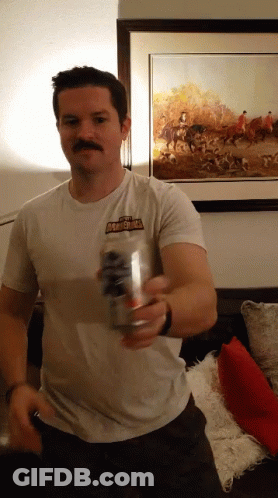 A Man Wearing A Shirt That Says Thunderbolt Holds A Can Of Beer GIF
