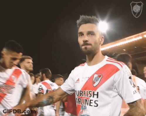 A Man Wearing A Shirt That Says Turkish Airlines Shakes Hands With His Teammates GIF