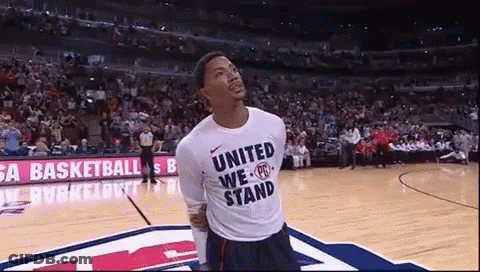 A Man Wearing A Shirt That Says United We Stand GIF