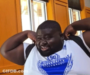A Man Wearing A Shirt That Says University On It GIF