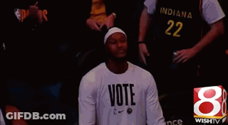A Man Wearing A Shirt That Says Vote GIF