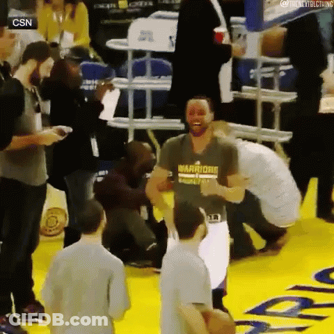 A Man Wearing A Shirt That Says Warriors On It Is Dancing On The Court GIF