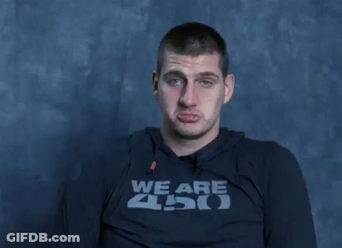 A Man Wearing A Shirt That Says We Are Zoo Is Making A Funny Face With His Hands . GIF